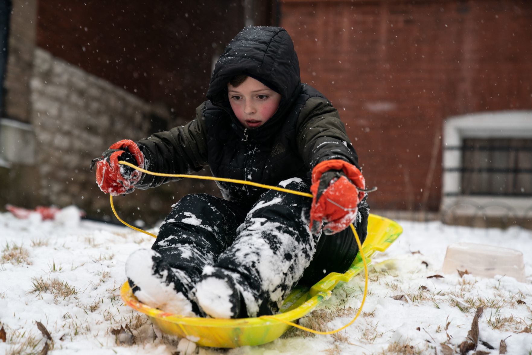 Boy sleds down his St. Louis yard
